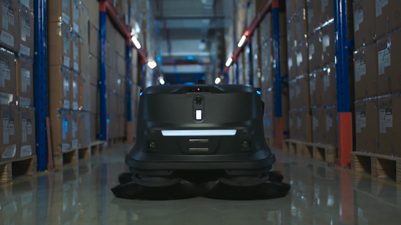 An MT1 sweeper in a pallet racking aisle